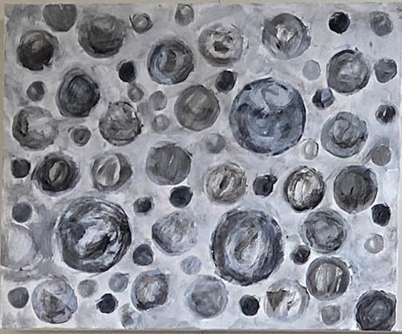 A painting of many circles in grey and black.